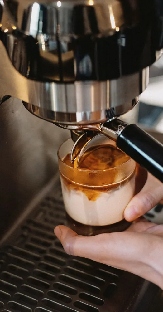 Close-up of a barista brewing coffee with an espresso machine in Tokyo, Japan.