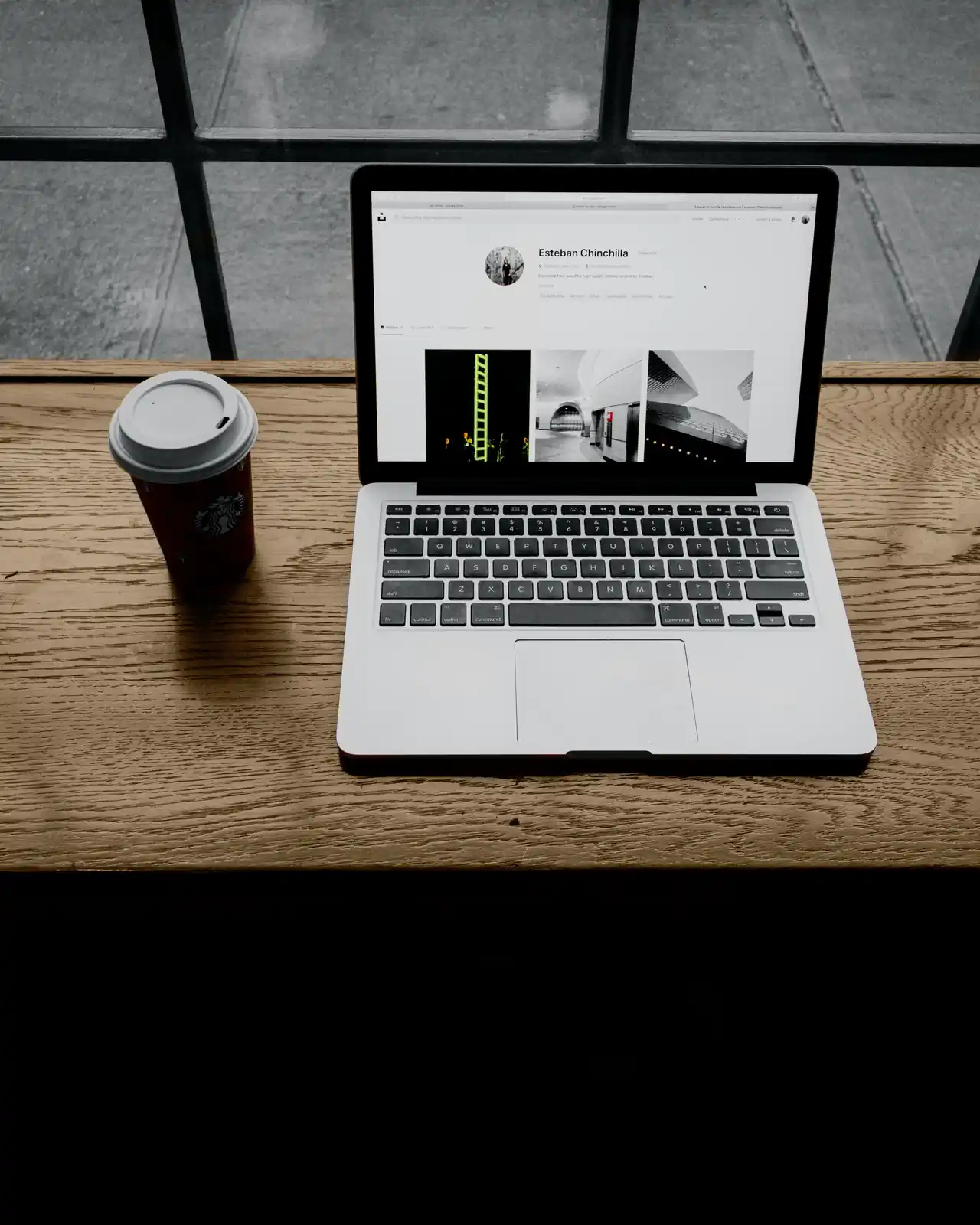 Small business owner working on a laptop beside a coffee cup